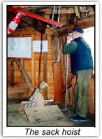 A volunteer mans the sack hoist