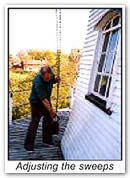 A volunteer closes the shutters with the weight